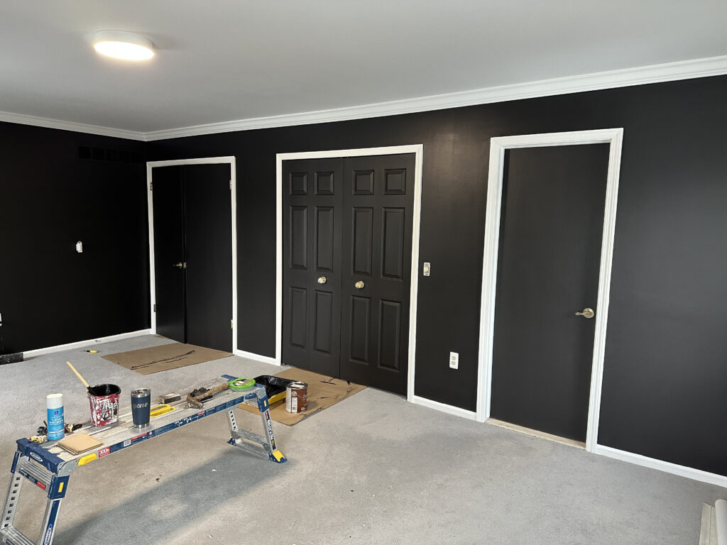 Freshly black painted bedroom with white trim